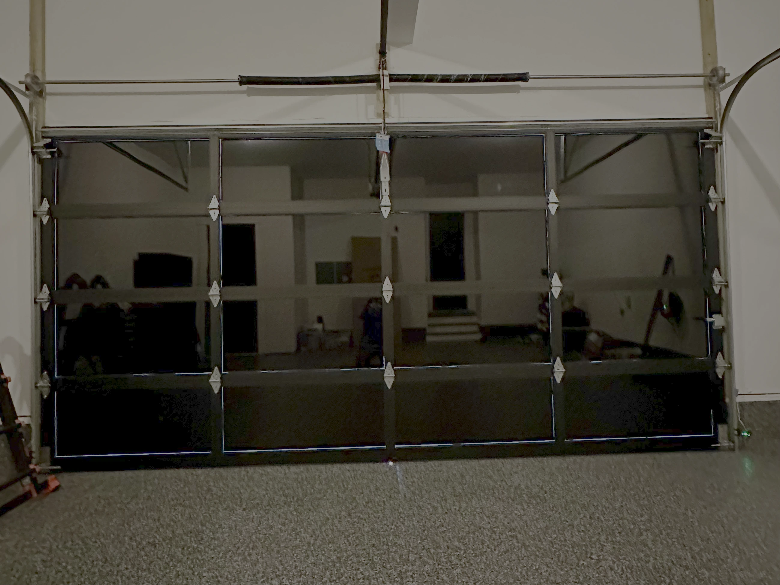 View from inside a garage with black tinted glass doors, providing privacy.