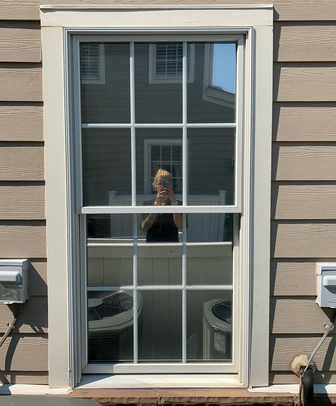 Home exterior with reflective solar control window film