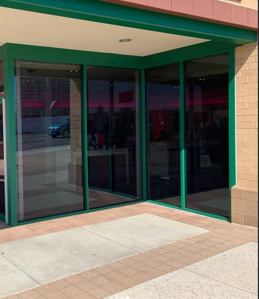 Storefront with ceramic solar control film, signal-friendly for retail displays